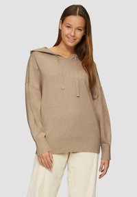 Beige Kapuzenpullover mit lockerer Passform, langen Ärmeln, gerippten Bündchen und Saum. Weicher Stoff; minimalistisches Design ohne Muster.