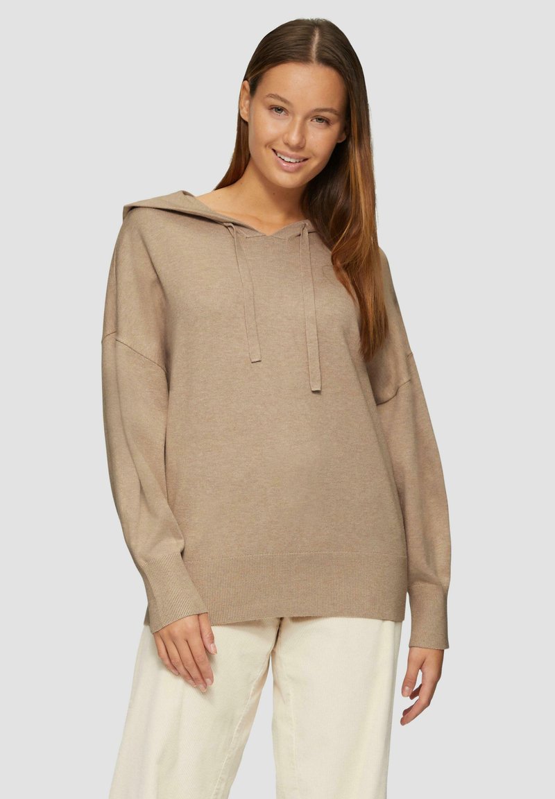 Beige Kapuzenpullover mit lockerer Passform, langen Ärmeln, gerippten Bündchen und Saum. Weicher Stoff; minimalistisches Design ohne Muster.