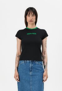 Black t-shirt with short sleeves and a green crew neck. Features a green "calvin klein" logo printed across the chest. Cotton material.