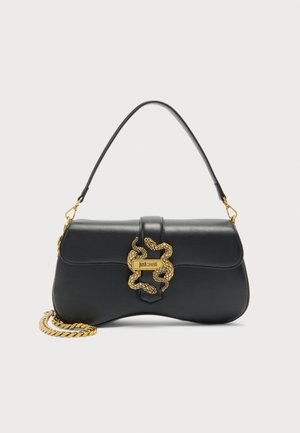 Black leather shoulder bag with gold snake-shaped clasp and chain detail, "Just Cavalli" logo on clasp, curved silhouette.