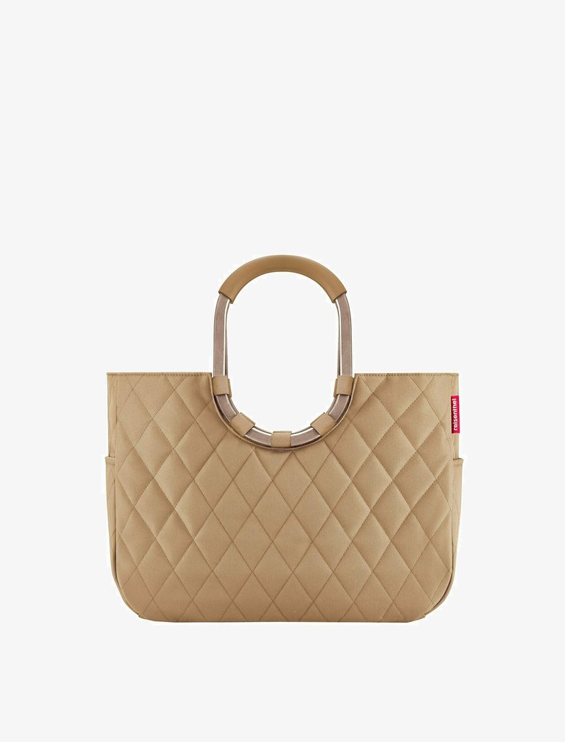 Beige quilted tote bag with two brown handles and a contrasting silver ring accent. Features side pockets and a structured rectangular shape.
