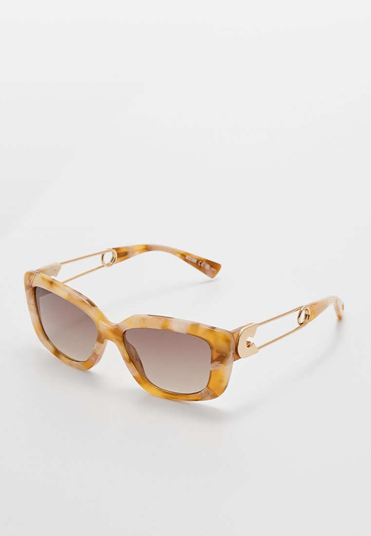Oversized square sunglasses with a tortoiseshell pattern, gradient brown lenses, gold accents, and a unique arm design.