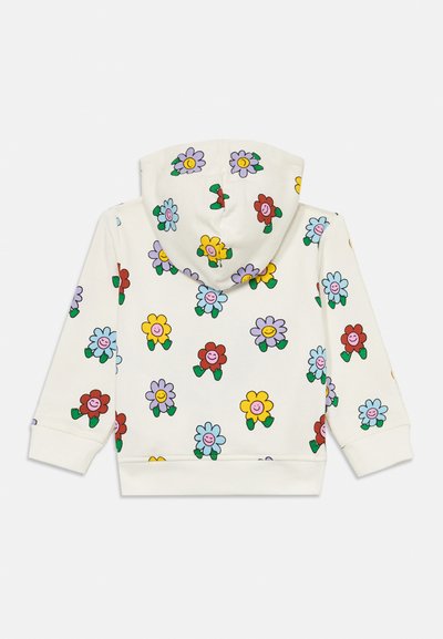 Kremfarget hettegenser med et gjentatt blomsterdesign i rødt, blått, gult og lilla, med grønne blader. Myk tekstur, ribbede mansjetter.