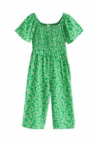 Zöld virágos overál rövid fodros ujjakkal, ráncolt felsőrésszel és bő szárakkal. A ruházat egészén fehér virágminták találhatók.