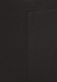 Gina Tricot Petite FLARE JERSEY TROUSERS - Παντελόνι - black