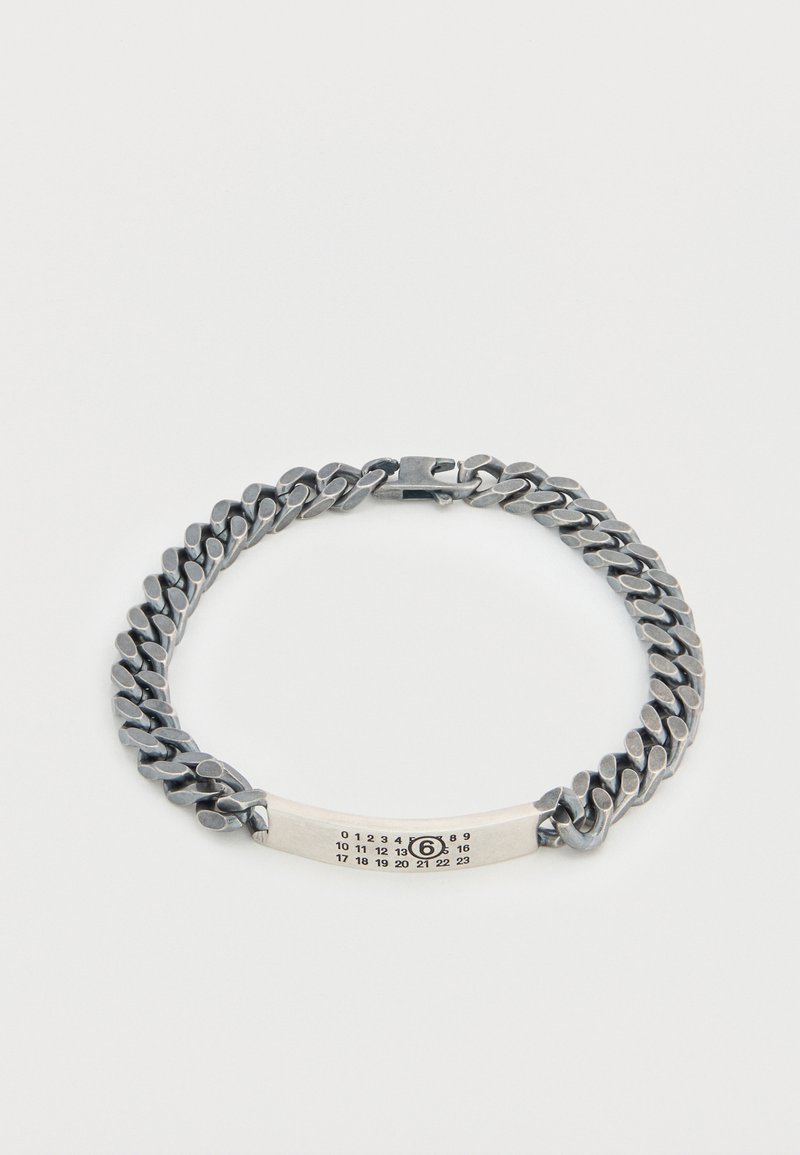 Bracelet chaîne ton argent avec maillons entrelacés. Comprend une section plate avec des chiffres gravés et une fermeture à boucle.