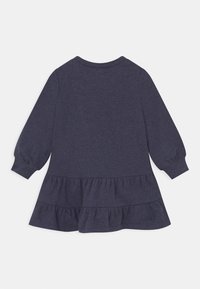 Marineblaues Langarmkleid mit abgestuftem, gerafftem Saum. Hergestellt aus weichem Stoff mit rundem Ausschnitt und elastischen Bündchen. Schlichtes Design.