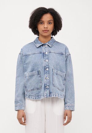 Light blue denim jacket with a collared neckline, front buttons, two large pockets, and a cropped hem. Smooth texture and relaxed fit.