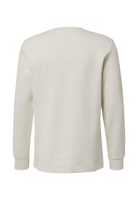 Licht beige lange mouwen shirt, gemaakt van zachte stof. Het heeft een ronde hals, geribbelde boorden en een eenvoudig, strak ontwerp zonder zichtbare logo's.