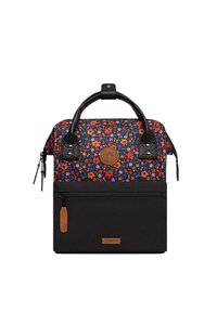 Rucksack aus Stoff mit Blumenmuster und schwarzem unteren Abschnitt, strukturierten schwarzen Griffen und einer Reißverschlusstasche vorne. Mit einem braunen Logo-Patch versehen.