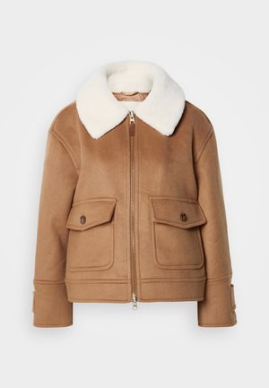 Veste en laine marron avec un col en fausse fourrure blanche, fermeture éclair, deux poches avant et larges manches avec détail de boutons. Texture douce.