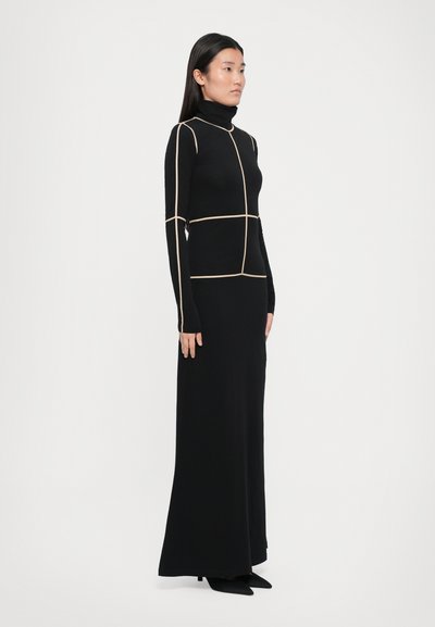 Black long-sleeve dress with a high neck, featuring cream geometric lines and a fitted silhouette that flows to the floor.