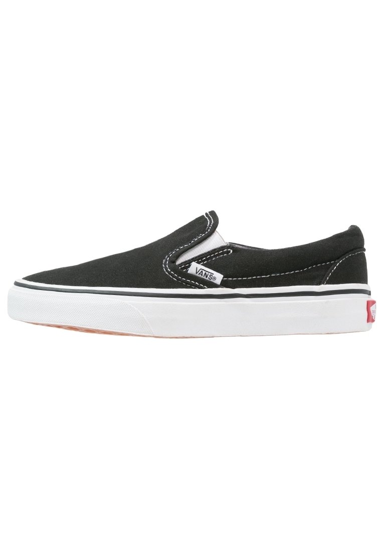 Baskets slip-on Vans noires avec semelle en caoutchouc blanche, coutures blanches et petite étiquette en tissu de marque sur le côté.