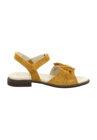 Yellow suede sandals with a knotted front detail, ankle straps, and a low, brown rubber sole. Flat design suitable for casual wear.
