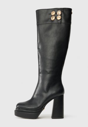 Black knee-high leather boot with chunky heel and platform sole, featuring four decorative gold buttons near the top edge.