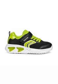 Scarpe da ginnastica nere e verde neon con tessuto a rete, una fascia in Velcro e suola in gomma bianca con dettagli distinti di trazione verdi.
