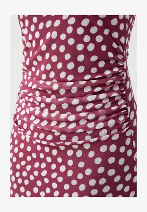 Purple fabric with white polka dots, featuring gathered detailing along the sides, creating a textured appearance.