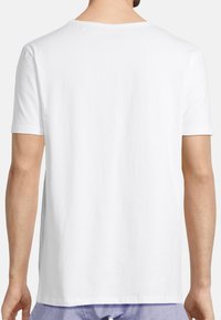 White short-sleeve T-shirt made of cotton, featuring a simple round neckline and smooth texture, viewed from the back.