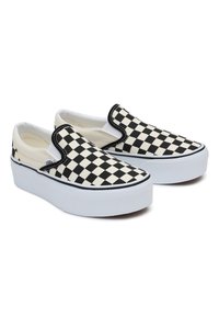 Zapatillas slip-on a cuadros en blanco y negro con una suela de goma blanca y un borde en negro que contrasta. Parte superior de suave tela de algodón.