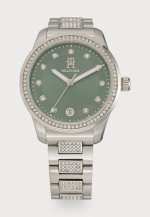 Silver-tone watch with a green dial, crystal accents, and a link bracelet. Features a round case, Arabic numerals, and date display.