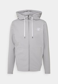 Grijze zip-up hoodie met witte strepen, verstelbare capuchon met trekkoorden, voorzakken en een logo detail op de borst.