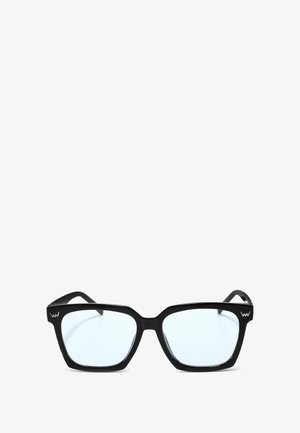 Black square sunglasses with clear lenses, thick plastic frames, and angular design. Features logo on the temple.