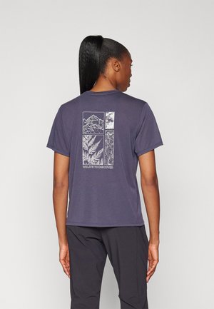 Navy t-shirt featuring a white graphic design on the back, displaying mountain and nature patterns, with the text "WE LIVE TO DISCOVER."