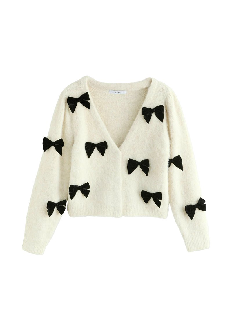 Weißer Cardigan aus weichem Material, mit V-Ausschnitt, langen Ärmeln und mehreren schwarzen Samtbows, die gleichmäßig auf der Vorderseite verteilt sind.