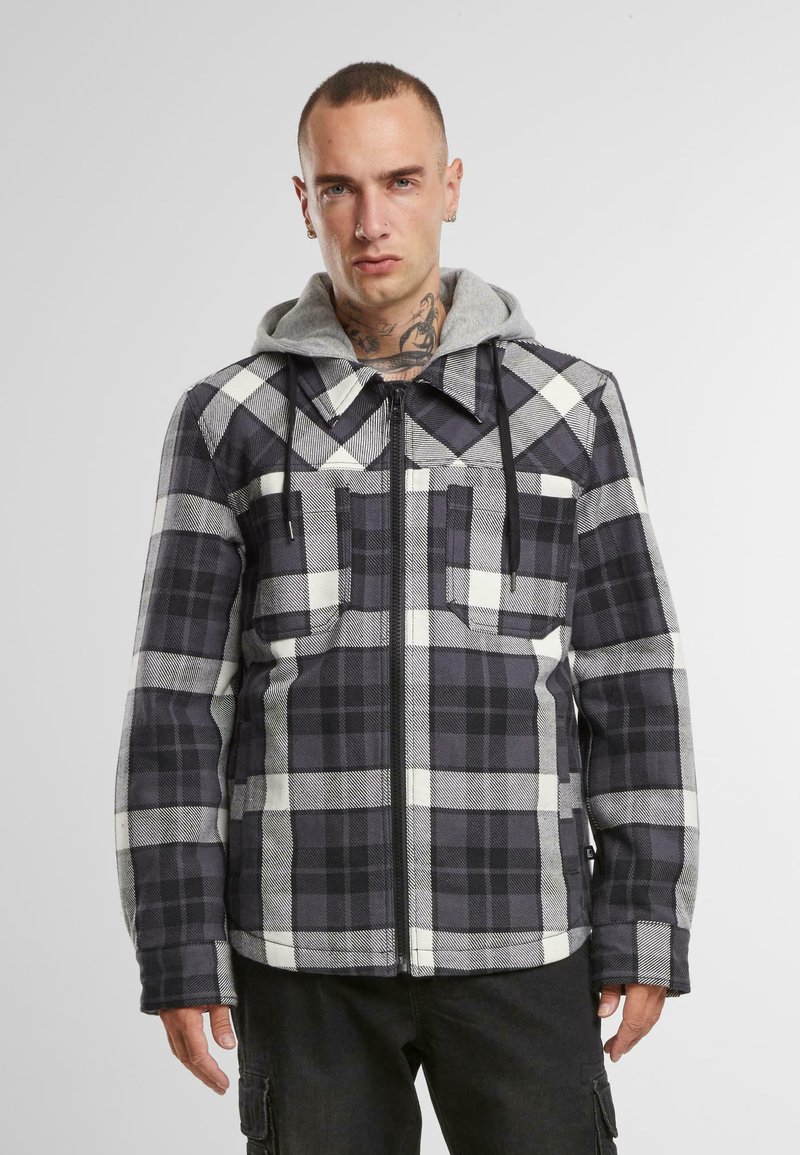 Grå rutete jakke med grå hette, med frontglidelås og to brystlommer. Stoffet har et mykt, teksturert utseende.