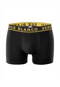 Boxer noir moulant, avec une ceinture élastique jaune imprimée "SERGE BLANCO" en noir. Texture lisse.