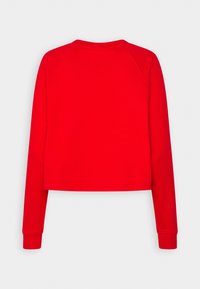 Czerwona skrócona bluza z długimi rękawami i ściągaczami, wykonana z gładkiego materiału o prostym, jednolitym kolorze.