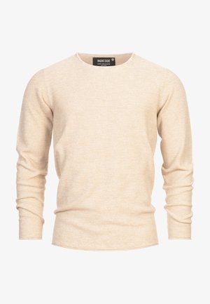 Beige lange mouwtrui gemaakt van een getextureerde gebreide stof. Heeft een ronde halslijn en aansluitende mouwen met een licht gebogen zoom.