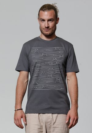 Graues Baumwoll-T-Shirt mit einem weißen Liniendesign von Katzen, das von wellenförmigen Linien durchzogen wird und sich über die Vorderseite erstreckt. Mit kurzen Ärmeln und Rundhalsausschnitt.