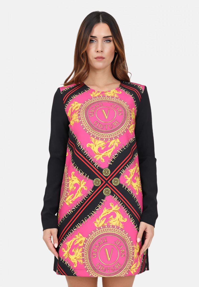 Frohen pinken Kleid mit langen schwarzen Ärmeln, verziert mit goldenen Mustern, einem kreisförmigen Logo und kontrastierendem schwarzen Saum entlang der Kanten.