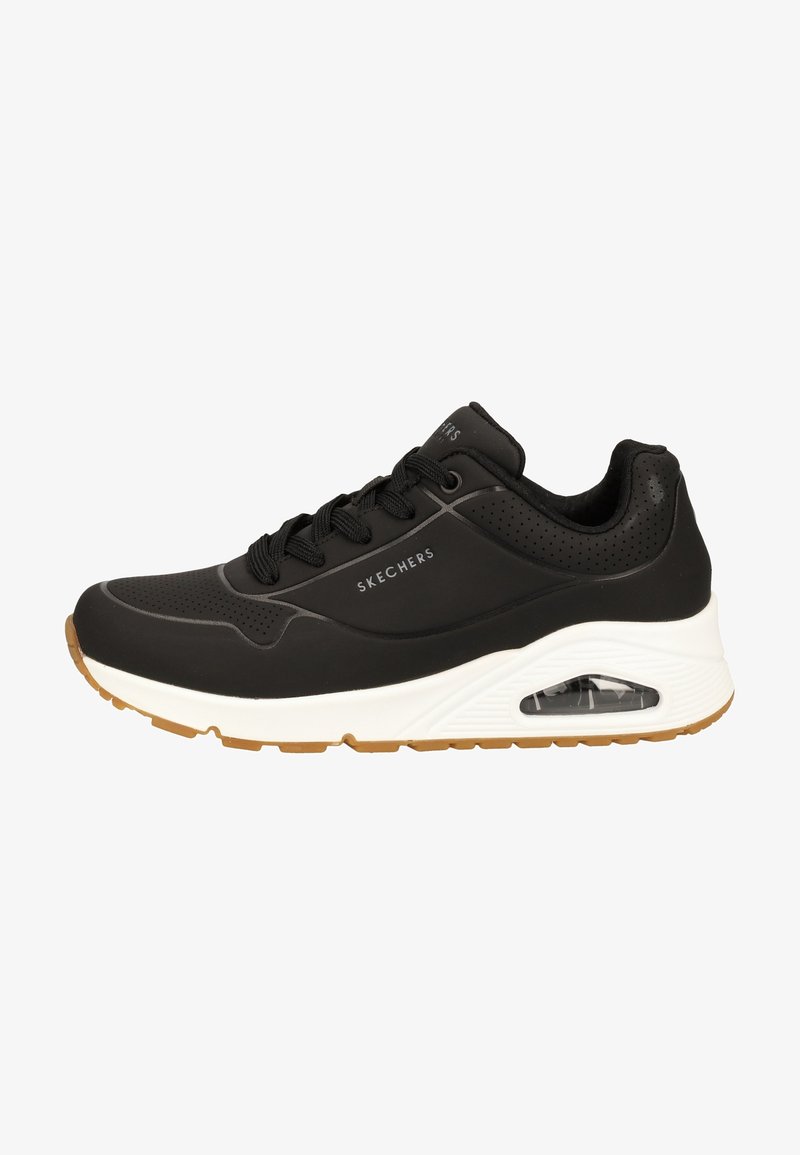 Basket noire Skechers avec laçage à l'avant, détails perforés, semelle blanche avec coussin d'air visible et semelle extérieure marron avec relief.
