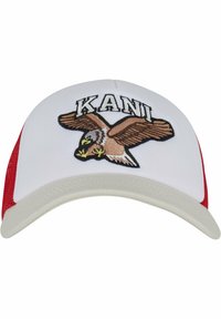 Baseballová čiapka s bielou prednou časťou, červenými sieťovanými stranami a béžovým okrajom. Na čiapke je vyšitý dizajn orla a nad ním text "KANI".