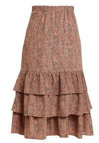 Jupe midi à volants en tissu brun clair moucheté, avec une taille élastique et trois couches de volants au bas.