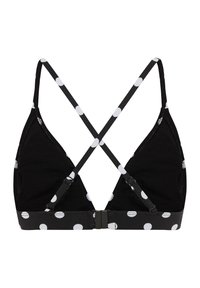 Crni trokutasti bralette s bijelim točkicama. Ima teksturiran podesivi remen u obliku križa i kopčanje na leđima.