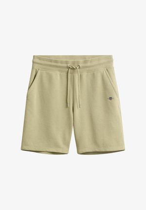 Beige knee-length cotton shorts with ribbed waistband, drawstring, side pockets, and small embroidered logo on the right leg.