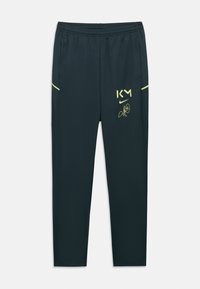 Μαύρο αθλητικό παντελόνι με ελαστική μέση, πλάγιες τσέπες και κίτρινες λογότυπα "KM" και Nike με υπογραφή στον δεξί μηρό.