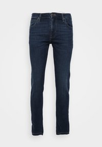 Pantalones vaqueros de mezclilla azul oscuro con corte ajustado, que cuentan con cinco bolsillos, una bragueta con cremallera y un ligero desvanecimiento en la parte delantera. Costura clásica y acabado de dobladillo.