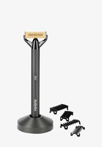 Trådløs hårtrimmer i matt svart med et blad i gullfarge. Inkluderer fire svarte kamtilbehør. Ergonomisk design og sirkulær base for stabilitet.