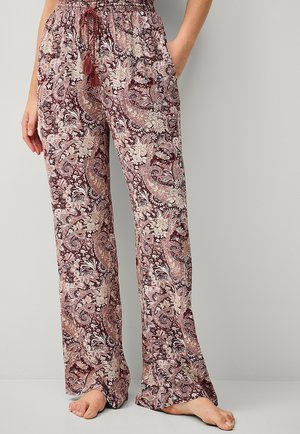 Løse, mønstrede bukser i bordeaux og creme med et paisley-design. Har en elastisk talje med snor og kvast-detaljer.
