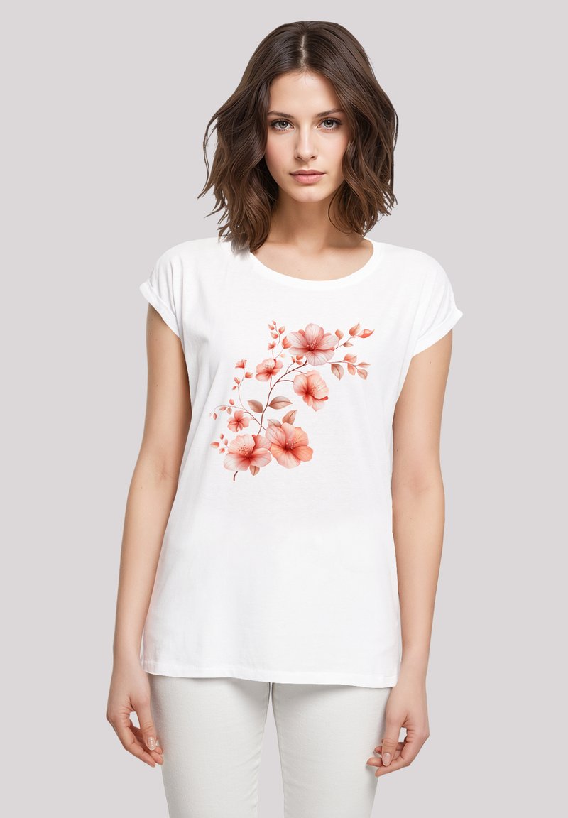White short-sleeve t-shirt with a floral print in shades of pink and peach, featuring soft fabric and a round neckline.
