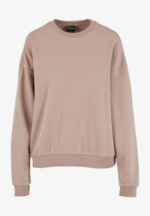 Rózsaszínű, puha anyagból készült kapucnija, laza fazonú, bordás mandzsettákkal és aljjal rendelkezik. Jellemzője a kerek nyak és a lógható vállak.