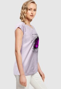 Light purple T-shirt with a butterfly graphic in the center, short sleeves, and a relaxed fit. Soft texture and breathable fabric.