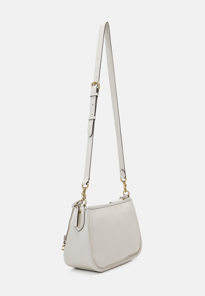 Arriba 120+ imagen white coach crossbody purse Abzlocal.mx