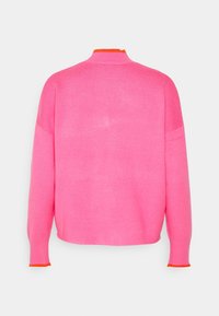 Pull rose vif à manches longues avec bordure orange au col montant et aux poignets, vu de dos sur fond blanc.