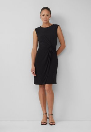 Black sleeveless dress with a round neckline, twisted detail at the waist, and a knee-length hem. Made of soft, stretchy fabric.