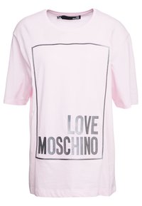 Růžové bavlněné tričko s volným střihem, s černým obdélníkovým rámečkem a nápisem "LOVE MOSCHINO" tištěným tučným písmem na přední straně.